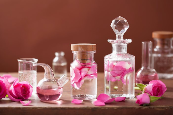 Bottles of Rose Water with Pink Roses