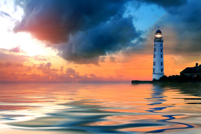 Lighthouse on the sea at sunset