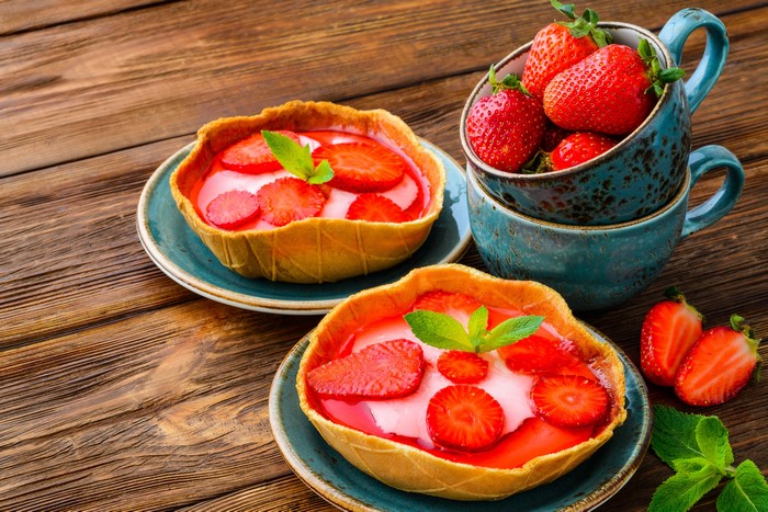 Strawberry tarts in cups and on plates