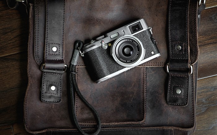 Retro camera on a leather bag
