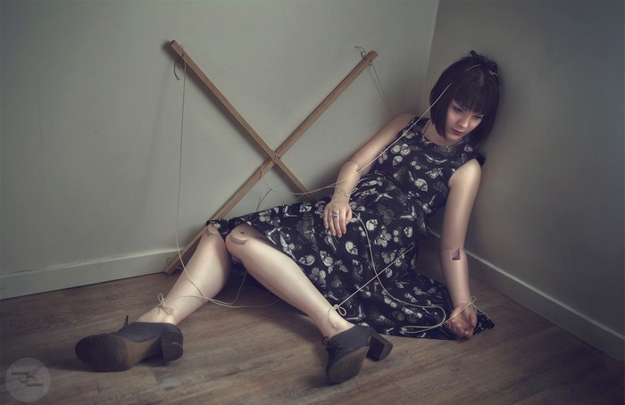 Woman dressed as a doll with strings