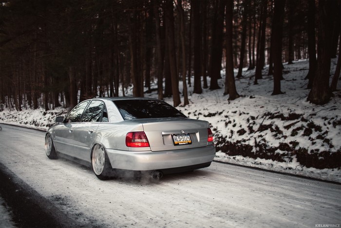 Audi A4 sedan driving on a snowy road