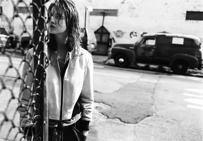 Lindsey Wixson behind a fence on a street