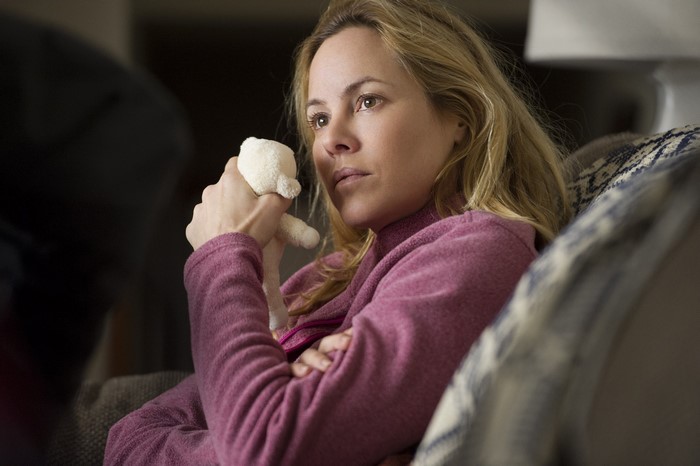 Maria Bello holding a stuffed animal