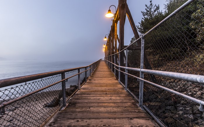 Wooden pier with street lights over the sea