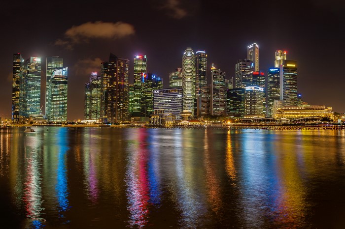 Singapore skyline at night with river reflections