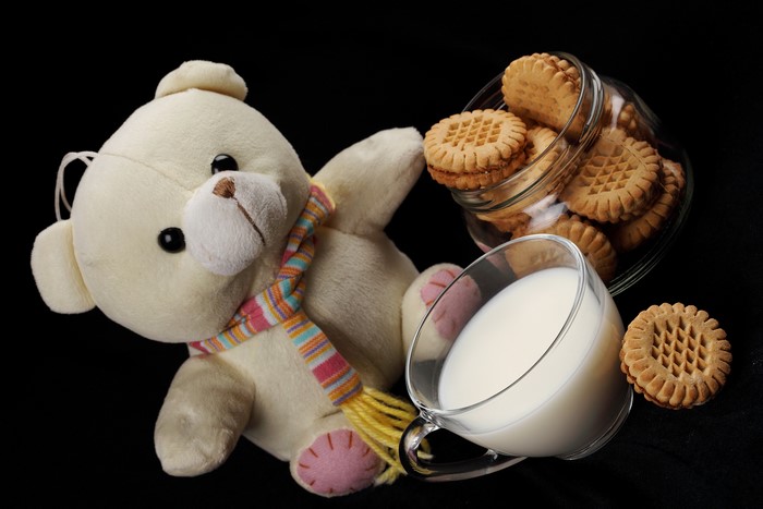 Teddy bear with milk and cookies
