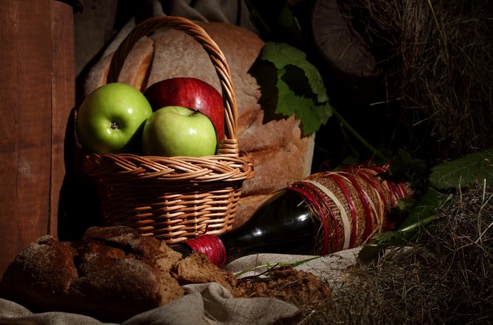 Apples, Wine, and Bread in a Wicker Basket