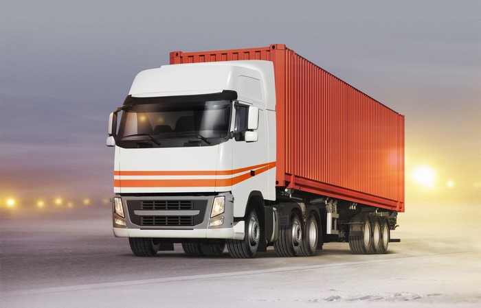 White truck with orange stripes and red container