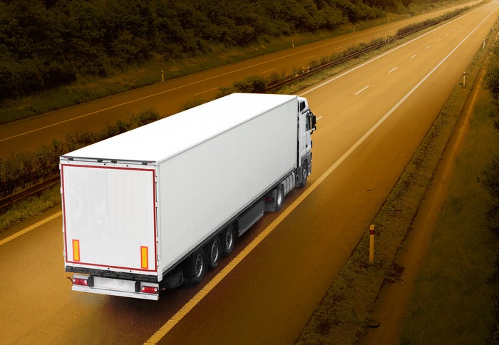 White semi-trailer truck on a highway