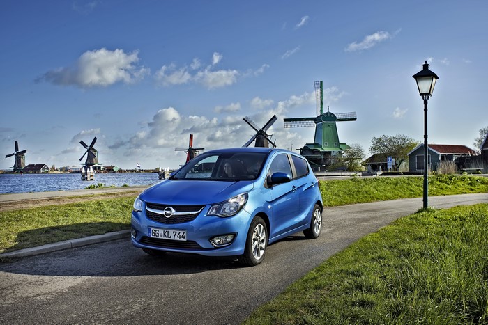 Blue Opel Karl on a road with windmills