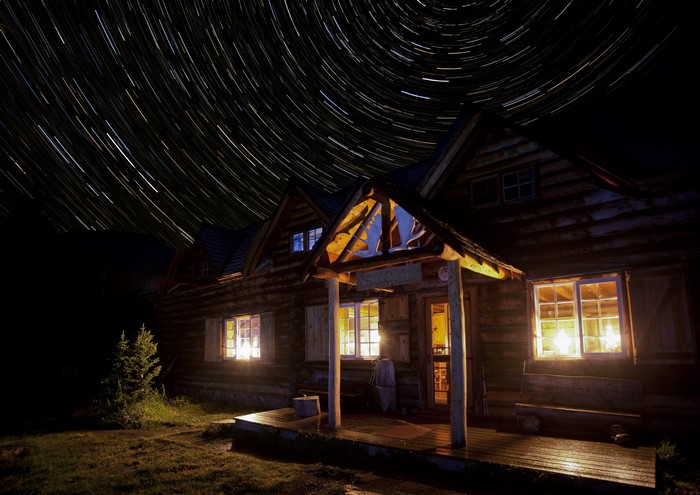 Log Cabin at Night with Star Trails