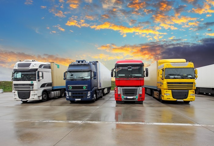 Four Trucks Parked Under a Dramatic Sky