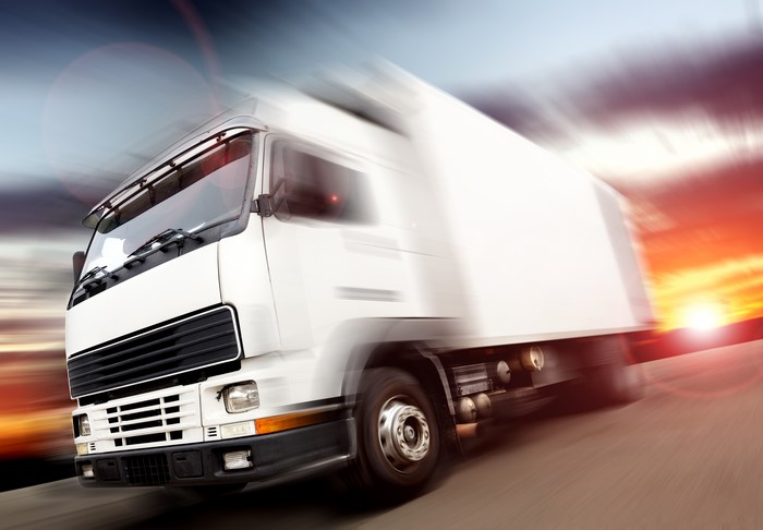 White Truck in Motion at Sunset