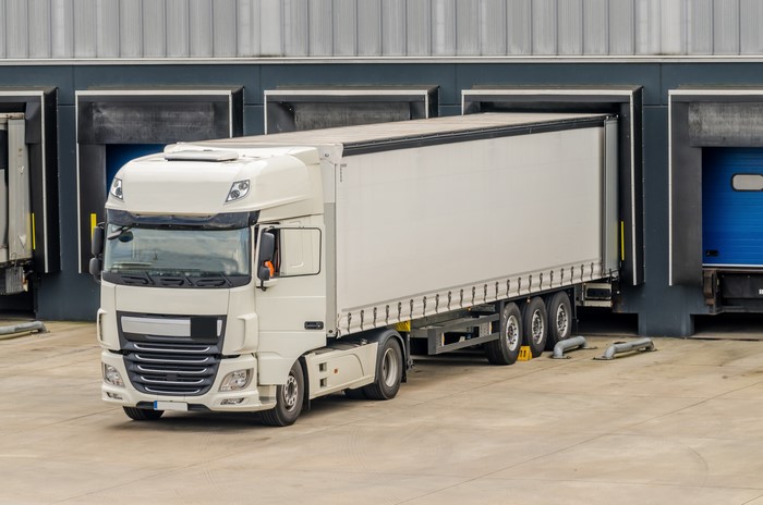 White semi-truck at a loading dock