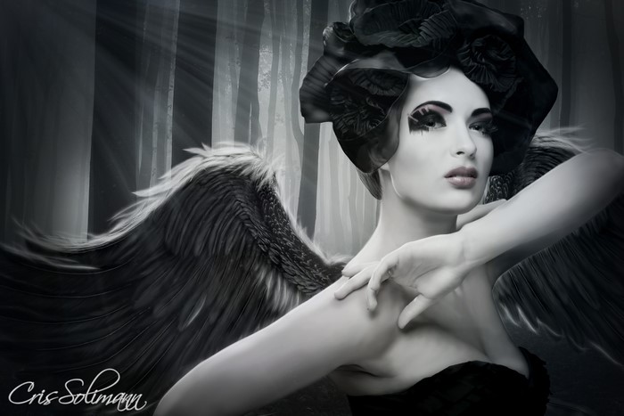 Angel with black wings in a forest