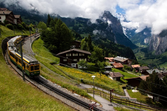 Train in Lauterbrunnen, Switzerland with Mountains and Houses
