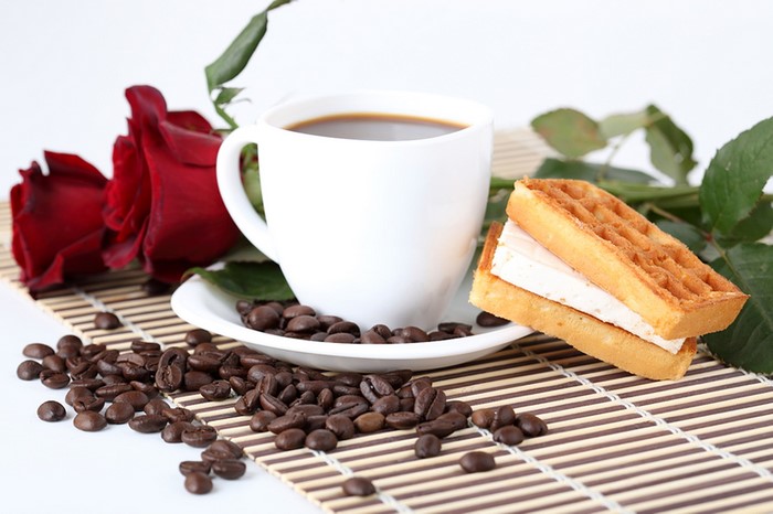 Still life of coffee, roses, and waffles