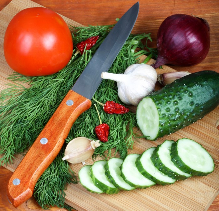 Vegetables and knife on a cutting board