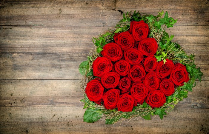 Heart of Red Roses on Wooden Background