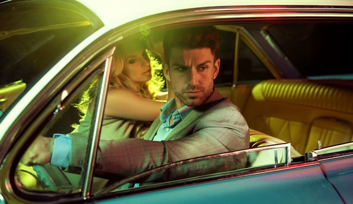 Man and Blonde Woman in Vintage Car