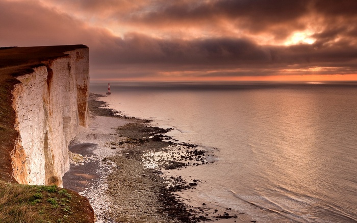 White cliffs and lighthouse at sunset