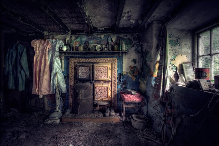 Abandoned room with dresses and fireplace