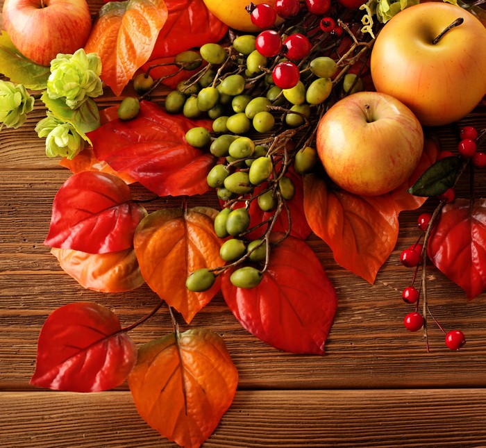 Autumn harvest with apples, berries, and leaves