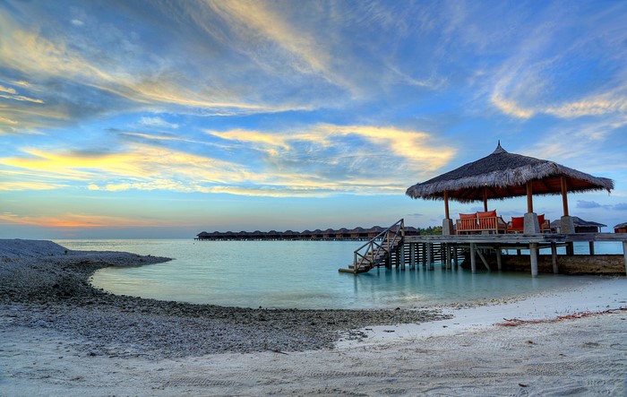 Maldives beach with overwater bungalows and gazebo