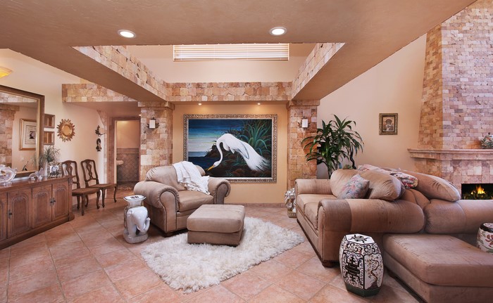 Living room with sofa, armchair, and pictorial art