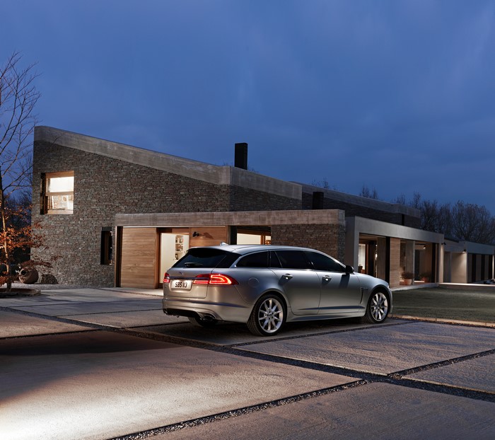 Jaguar XF Sportbrake parked in front of modern house