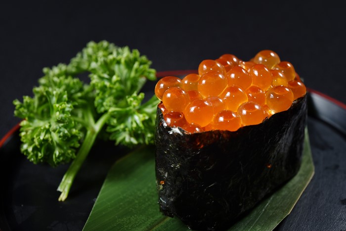 Sushi with salmon roe and parsley