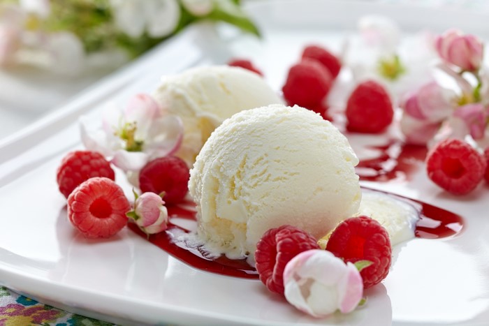 Ice cream with raspberries and flowers
