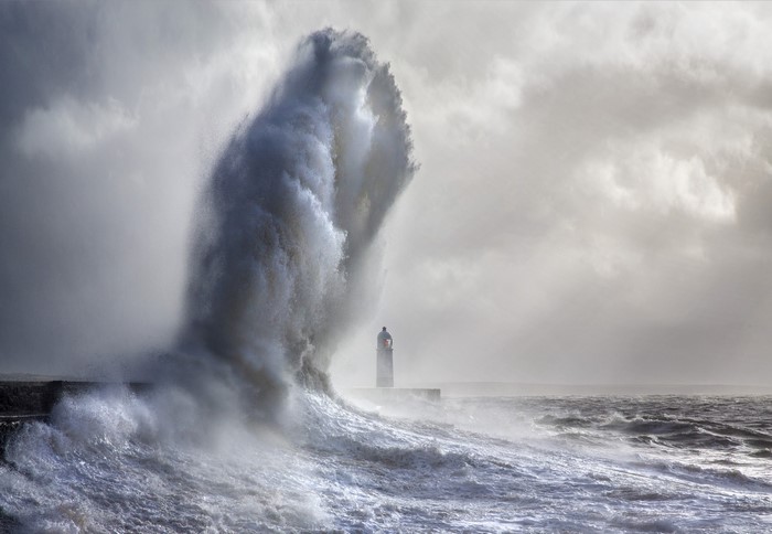 Massive wave crashing near Porthcawl Lighthouse in Wales