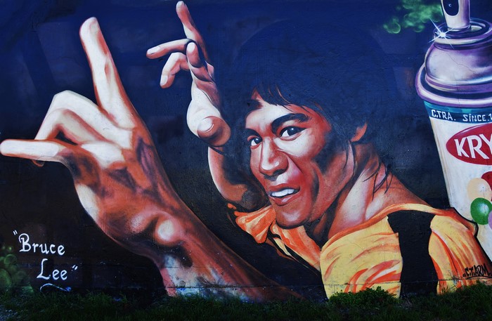 Graffiti of Bruce Lee with spray can