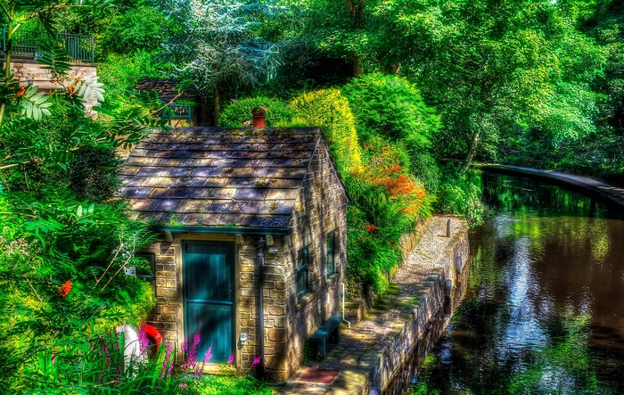 Stone cottage by a canal in Uppermill, England