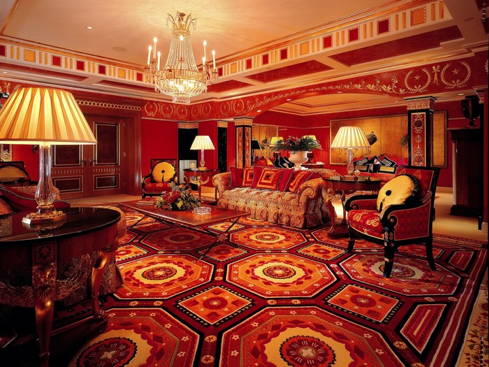 Luxurious living room with red walls and ornate carpet
