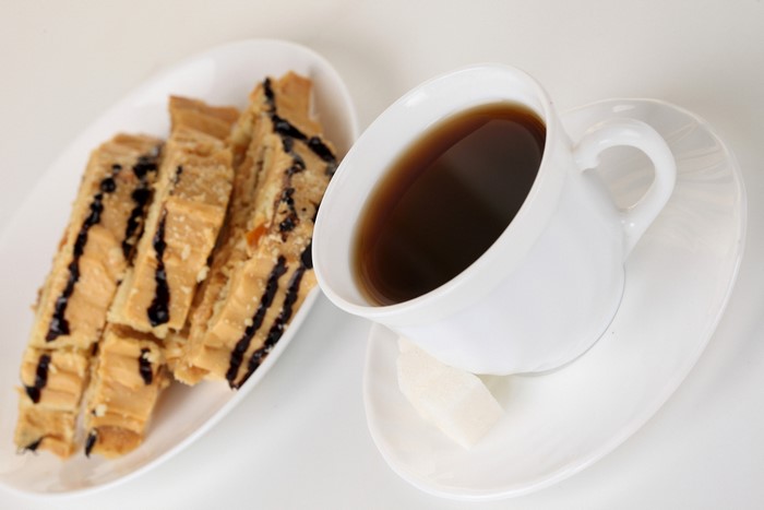 Coffee cup with saucer and biscotti on a plate