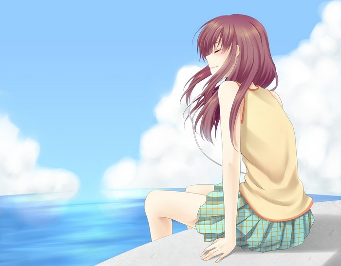 Girl with brown hair sitting by the sea