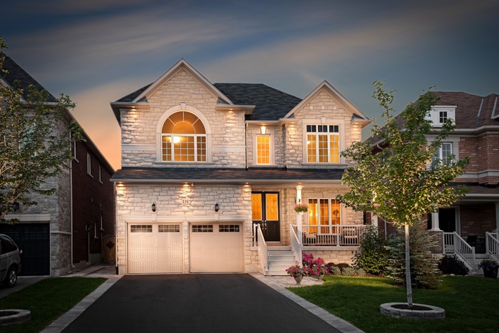 Luxury Stone House with Double Garage at Dusk