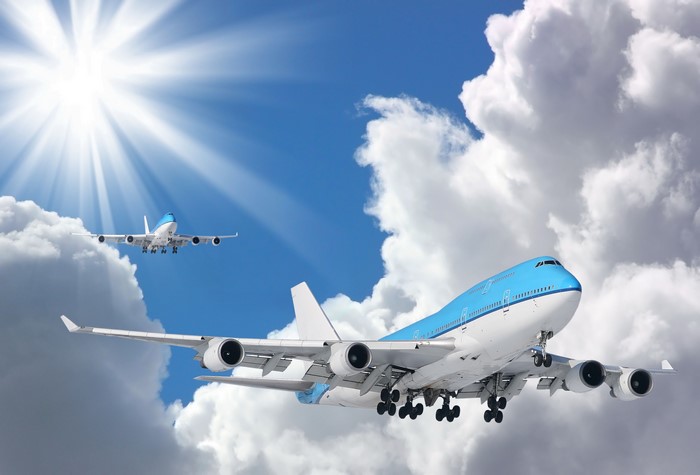 Boeing 747-400 Airplanes Flying in Clouds with Sun