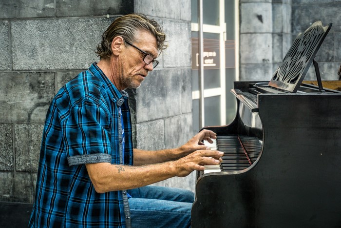Man playing a street piano