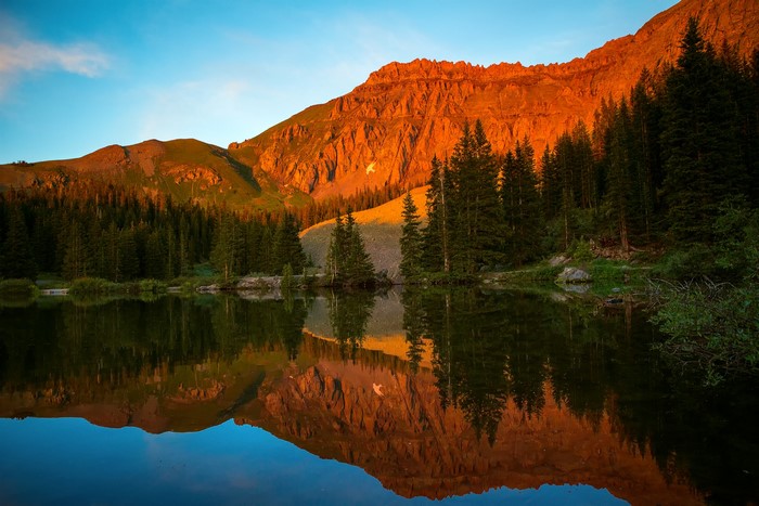 Mountain range reflecting in a lake at sunset, San Miguel, Colorado, USA