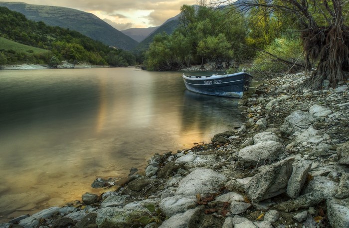 Boat on a rocky shore of a mountain lake