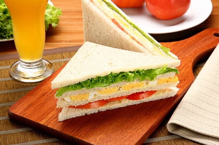 Egg and tomato sandwich with orange juice