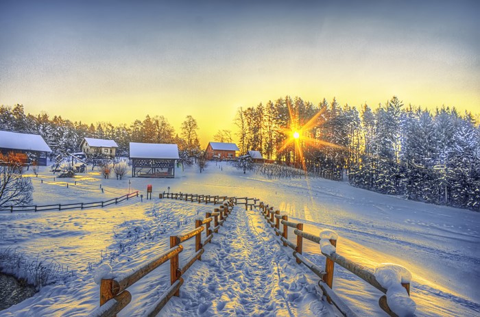 Winter village with sun and fence