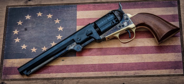 Antique revolver on a vintage American flag