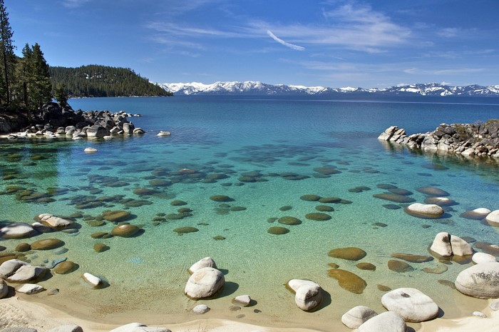 Lake Tahoe with Snow-Capped Mountains and Rocky Shore
