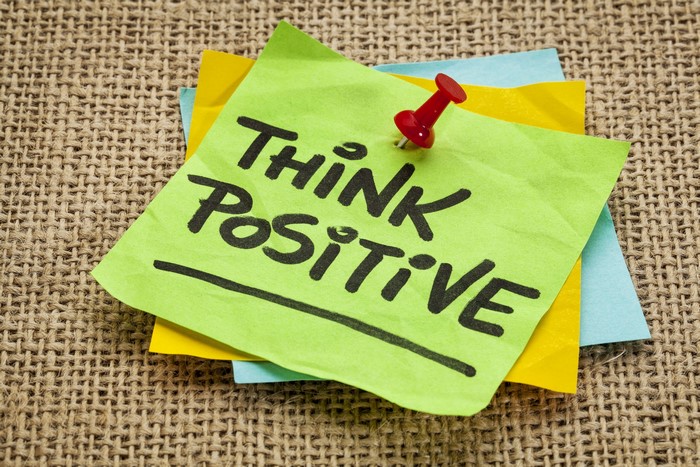 Think Positive sticky note with red pushpin