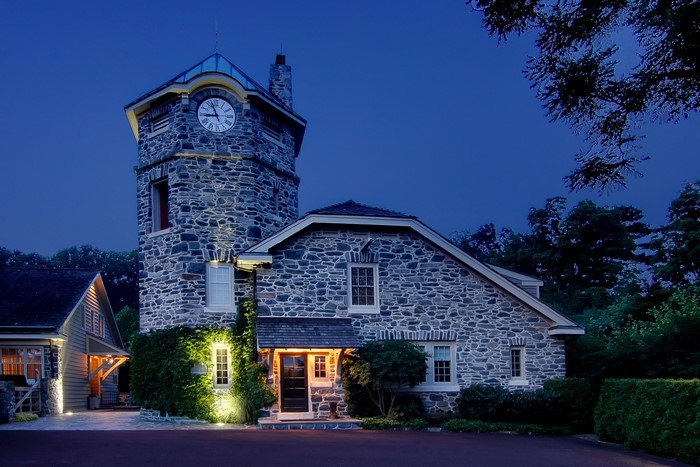 Stone house with a clock tower at night